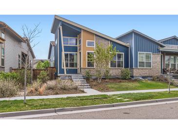 Striking modern home with a well-maintained front yard and unique architectural details at 9422 E 58Th Pl, Denver, CO 80238
