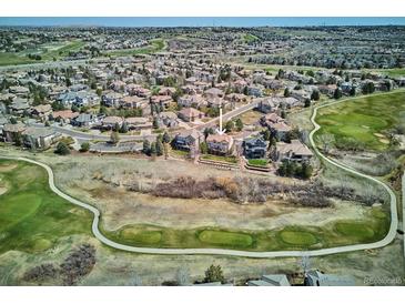 Beautiful aerial view of a suburban home with golf course views, a landscaped yard, and close proximity to other homes at 6971 S Netherland Way, Aurora, CO 80016
