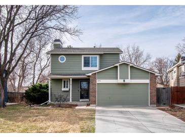Charming two-story home with attached two-car garage and a well-maintained front yard at 6306 Xavier St, Arvada, CO 80003