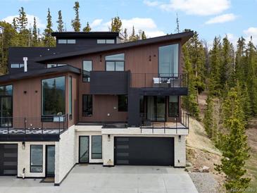 An eye-level view of a modern exterior showcasing its architectural features, balconies, and mountain views at 436 N Fuller Placer Rd, Breckenridge, CO 80424