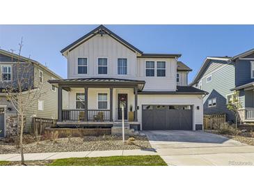 Charming two-story home with white siding, a welcoming front porch, and a two-car garage at 2840 E 102Nd Pl, Thornton, CO 80229
