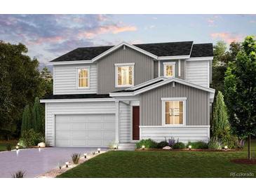 Charming two-story home with a two-car garage, manicured lawn, and inviting curb appeal at 14123 Bunny Hop Ln, Parker, CO 80134