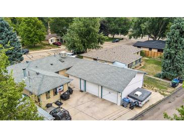 An aerial view showcasing a property with a spacious driveway and multiple-car garage at 1217 Lincoln St, Longmont, CO 80501