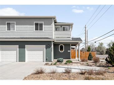Charming two-story home with a two-car garage and beautifully landscaped front yard at 3402 N Clayton St, Denver, CO 80205
