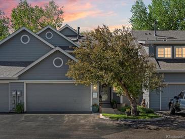 Charming two-story home with a well-manicured front yard, complemented by a cozy two-car garage at 5006 S Nelson St # B, Littleton, CO 80127