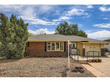 Charming brick single-story home featuring a well-maintained lawn, covered entryway, and attached garage at 2692 S Osceola St, Denver, CO 80219