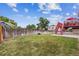 Spacious backyard with patio area, a fire pit, and access to the outdoor deck at 693 Delwood Ct, Highlands Ranch, CO 80126