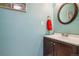 Powder room with vanity and accent mirror at 693 Delwood Ct, Highlands Ranch, CO 80126