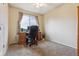 Bright bedroom featuring neutral carpeting, a large window, and a wooden desk set at 693 Delwood Ct, Highlands Ranch, CO 80126