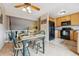 Cozy dining area with wood floors, a painted table setting for four, and kitchen access at 693 Delwood Ct, Highlands Ranch, CO 80126