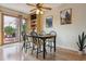 Inviting dining area featuring a table for four and an outdoor view with access to an elevated deck at 693 Delwood Ct, Highlands Ranch, CO 80126