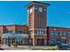 A vibrant shopping center with a clock tower, various businesses, and ample parking at 693 Delwood Ct, Highlands Ranch, CO 80126
