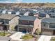 Aerial view of a home featuring solar panels, a neat lawn, a paved driveway, and mountain views in the background at 1914 Villageview Ln, Castle Rock, CO 80104