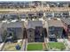 An aerial view showcasing a home's backyard with artificial turf, a deck, and its position within a well-planned community at 1914 Villageview Ln, Castle Rock, CO 80104