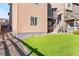Home backyard with artificial turf, rock landscaping, and a convenient staircase at 1914 Villageview Ln, Castle Rock, CO 80104