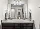 Elegant bathroom with double sinks, granite countertop, and a large mirror reflecting the space at 1914 Villageview Ln, Castle Rock, CO 80104