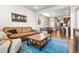 Comfortable living room with a leather sofa, rustic coffee table, and a vibrant blue patterned rug at 1914 Villageview Ln, Castle Rock, CO 80104