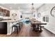 Open-concept living and dining area features modern decor and a large dining table with bench seating at 1914 Villageview Ln, Castle Rock, CO 80104