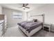 Bright bedroom featuring a comfortable bed with storage drawers and a serene view from the window at 1914 Villageview Ln, Castle Rock, CO 80104