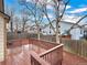 A fenced back yard featuring a wood deck and decorative mulch, providing an inviting outdoor space at 13661 Adams St, Thornton, CO 80602