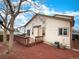 View of house with wood deck, back yard area featuring decorative mulch and mature trees, enhancing outdoor enjoyment at 13661 Adams St, Thornton, CO 80602