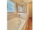 Bathroom featuring a bathtub and shower with glass door at 13661 Adams St, Thornton, CO 80602