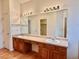 Bathroom featuring dual sinks, large mirror, and wood-look floors at 13661 Adams St, Thornton, CO 80602