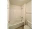 Bathroom featuring a combination shower/tub with white tiling and a functional toilet at 13661 Adams St, Thornton, CO 80602