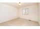 This bedroom boasts neutral walls, soft carpeting, and a window for natural light at 13661 Adams St, Thornton, CO 80602