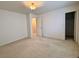 This bedroom features neutral walls, plush carpet, and entryways to the closet and bathroom at 13661 Adams St, Thornton, CO 80602