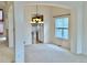 Open-concept dining area with view to kitchen features archways, neutral paint, and updated lighting at 13661 Adams St, Thornton, CO 80602