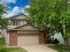 Charming two-story home featuring a brick facade and a well-maintained front yard at 13661 Adams St, Thornton, CO 80602