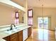 Bright eat-in kitchen with stainless appliances and hardwood floors at 13661 Adams St, Thornton, CO 80602
