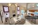 Open-concept living area with a fireplace, adjacent dining space, and a modern kitchen at 13661 Adams St, Thornton, CO 80602