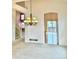 Open concept living area with updated lighting and view to stairway, and access to backyard deck at 13661 Adams St, Thornton, CO 80602