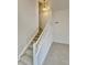 Carpeted staircase illuminated by hanging light fixture, leading to the upper level of the home at 13661 Adams St, Thornton, CO 80602