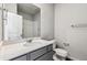 Well-lit bathroom features a granite vanity top, modern fixtures, a shower, and a white toilet at 5742 Ranch St, Mead, CO 80504