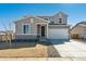 Charming two-story home featuring a two car garage, gray siding and rock landscaping at 5742 Ranch St, Mead, CO 80504