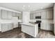 Well-appointed kitchen with gray cabinets, an island, stainless steel appliances, and recessed lighting at 5742 Ranch St, Mead, CO 80504