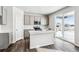 Contemporary kitchen boasts gray cabinetry, an island, stainless steel appliances, and ample natural light at 5742 Ranch St, Mead, CO 80504