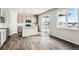 Modern kitchen featuring gray cabinets, an island, stainless steel appliances, and sliding doors to the outside at 5742 Ranch St, Mead, CO 80504