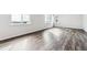 Spacious living room with a large window, light-colored walls, and wood floors, perfect for Gathering gatherings at 5742 Ranch St, Mead, CO 80504