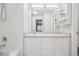 Bright bathroom features a large mirror, white cabinetry, and tub with shower at 12711 Colorado Blvd # 1009, Thornton, CO 80241