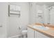 Bathroom featuring a vanity with sink, toilet, and tiled shower at 12711 Colorado Blvd # 1009, Thornton, CO 80241