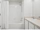 Clean bathroom featuring a tub/shower combo with white tiling and sink at 12711 Colorado Blvd # 1009, Thornton, CO 80241