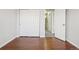 Bedroom with wood floors, closet, and hallway entrance at 12711 Colorado Blvd # 1009, Thornton, CO 80241