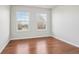 Bright bedroom features two windows, hardwood floors, and ample space at 12711 Colorado Blvd # 1009, Thornton, CO 80241
