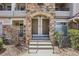 Close-up of a townhouse entrance featuring stone archways, dual doors, and a concrete stoop at 12711 Colorado Blvd # 1009, Thornton, CO 80241