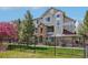 Attractive multi-story townhome featuring stone accents and a secure, modern wrought iron fence at 12711 Colorado Blvd # 1009, Thornton, CO 80241