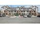 Home exterior featuring stone accents, parking, and landscaping at 12711 Colorado Blvd # 1009, Thornton, CO 80241